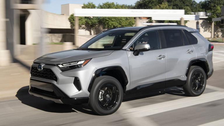 2023 Toyota RAV4 Hybrid driving in silver